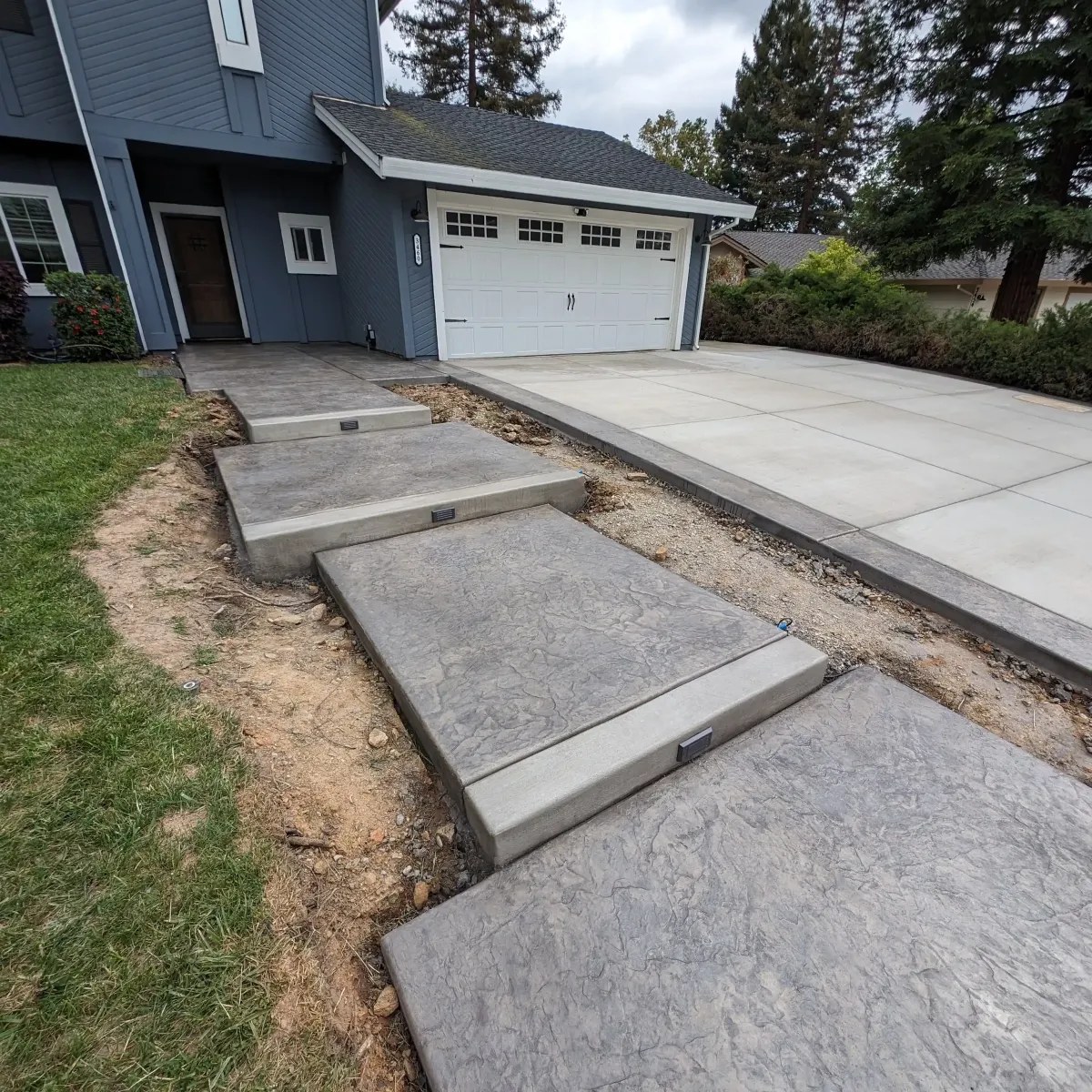 Custom concrete walkway alongside a home